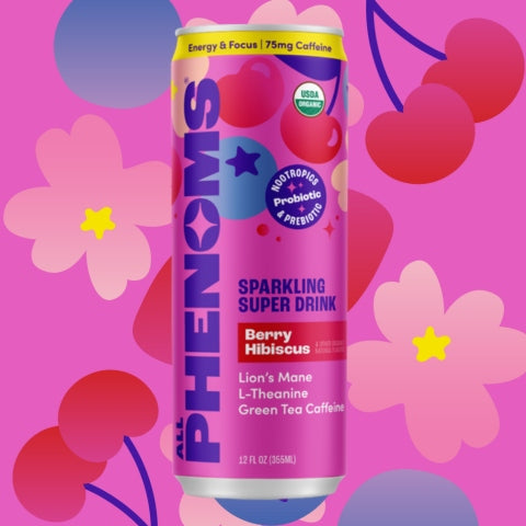 Canned All Phenoms Berry Hibiscus sparkling super drink with colorful design on a pink background with flowers, blueberries and cherries.